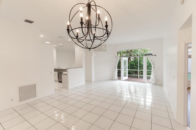 unfurnished room with light tile patterned floors, visible vents, and an inviting chandelier