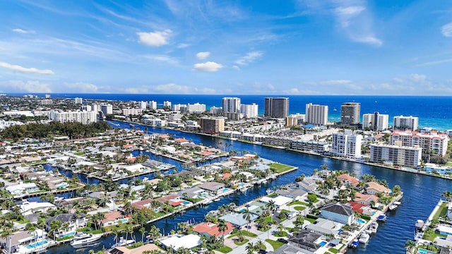 drone / aerial view with a city view and a water view