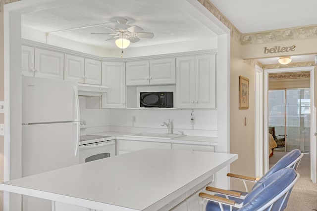 kitchen with white appliances, ceiling fan, sink, and white cabinets