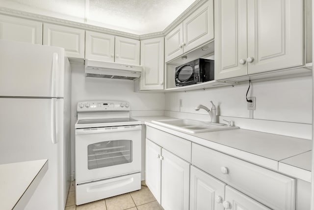 kitchen with sink, white appliances, light tile patterned floors, a textured ceiling, and white cabinets