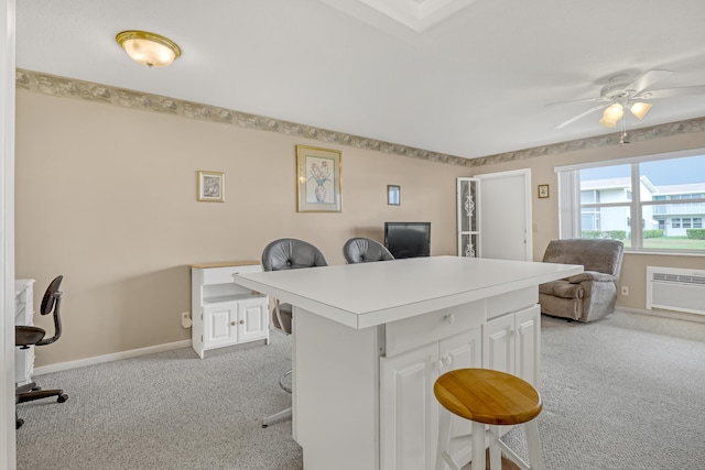 carpeted office with ceiling fan and a wall mounted AC