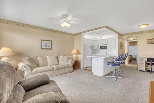 living room featuring light carpet and ceiling fan