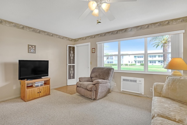 living room featuring a wall unit AC, light carpet, and ceiling fan