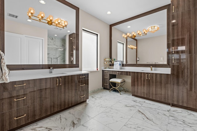 full bath with marble finish floor, a marble finish shower, two vanities, visible vents, and a sink