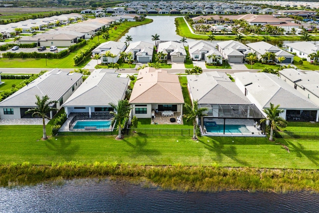 drone / aerial view featuring a water view and a residential view