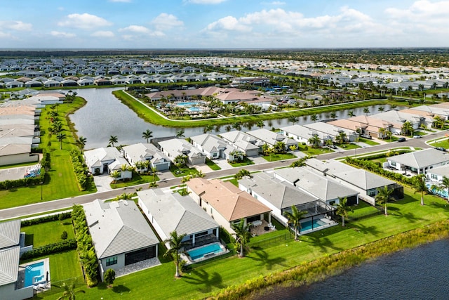 birds eye view of property with a water view and a residential view