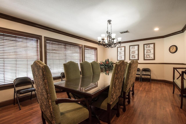 dining space featuring dark wood-style floors, visible vents, ornamental molding, a chandelier, and baseboards