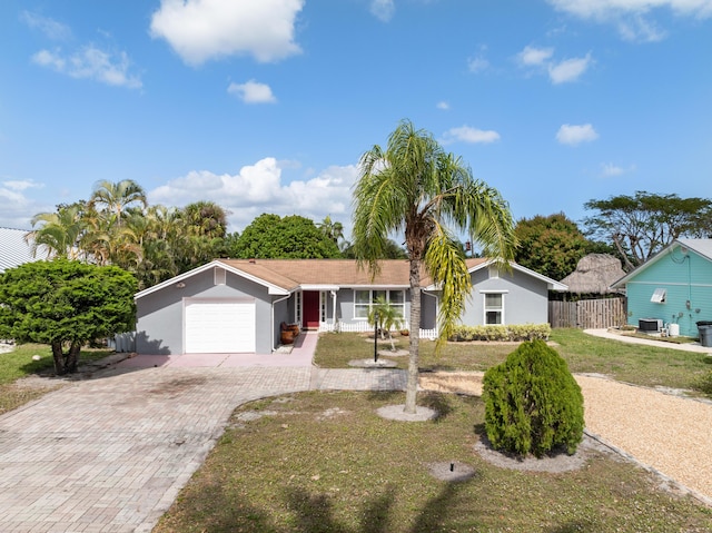 ranch-style home featuring a front lawn and a garage