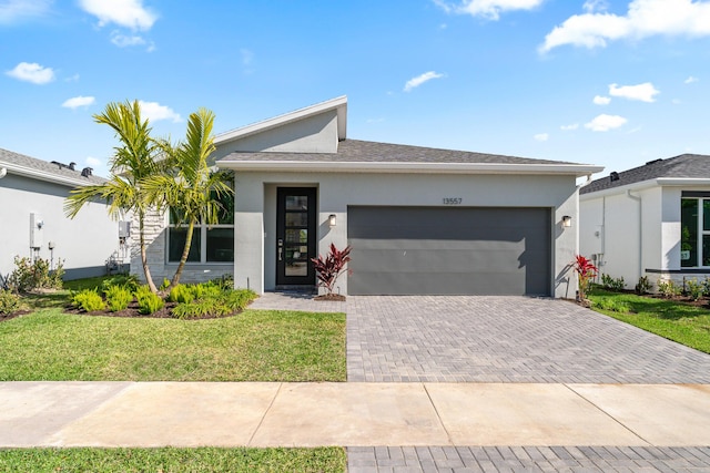 single story home with a garage and a front yard