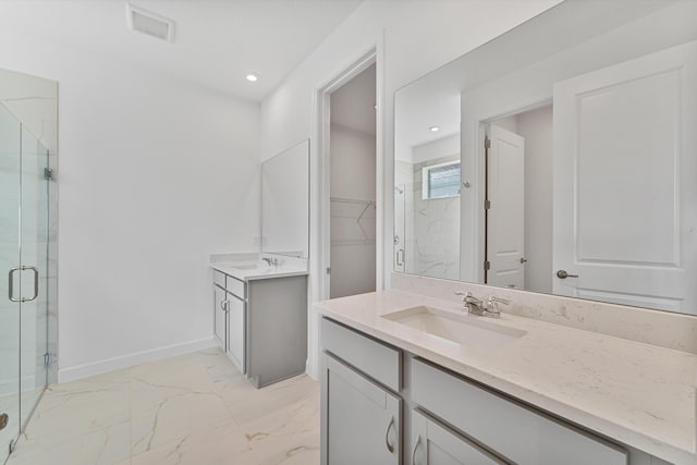 bathroom featuring vanity and a shower with shower door