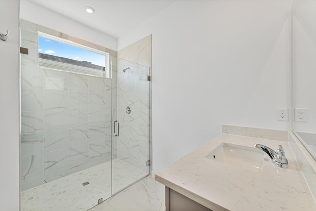 bathroom with an enclosed shower and vanity