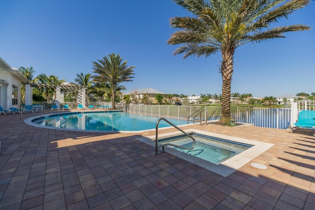 view of pool featuring a patio area, a water view, and a community hot tub