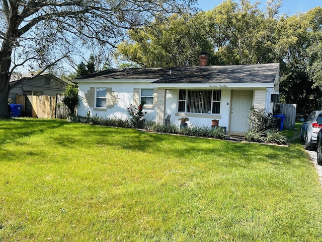 ranch-style home with a front lawn