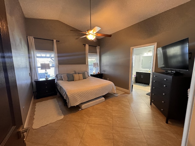 bedroom featuring light tile patterned flooring, ensuite bath, vaulted ceiling, and multiple windows