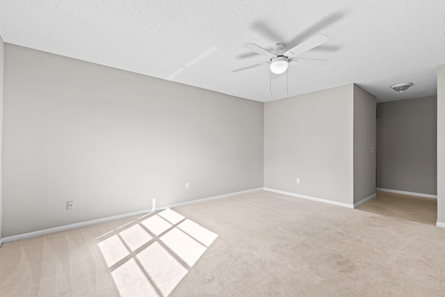 carpeted empty room with a textured ceiling and ceiling fan