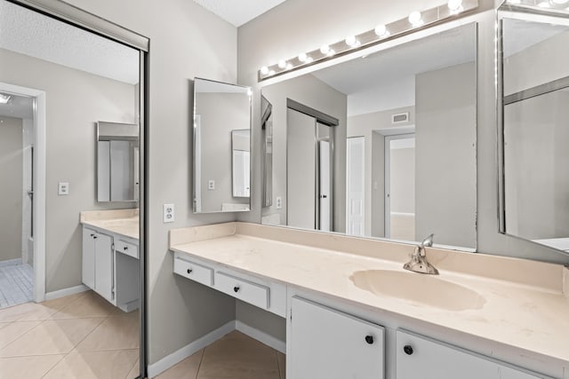 bathroom featuring vanity and tile patterned flooring