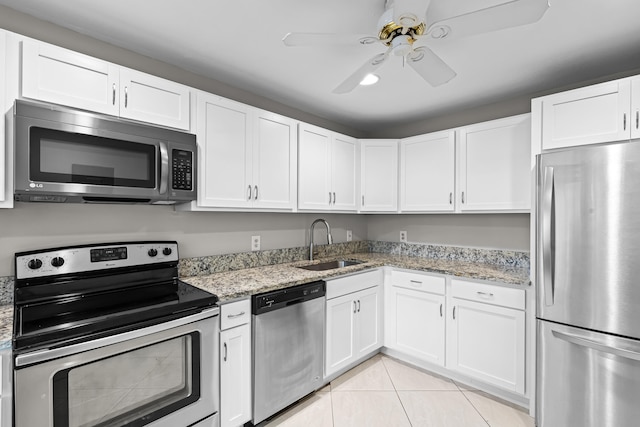 kitchen featuring light stone counters, sink, and stainless steel appliances