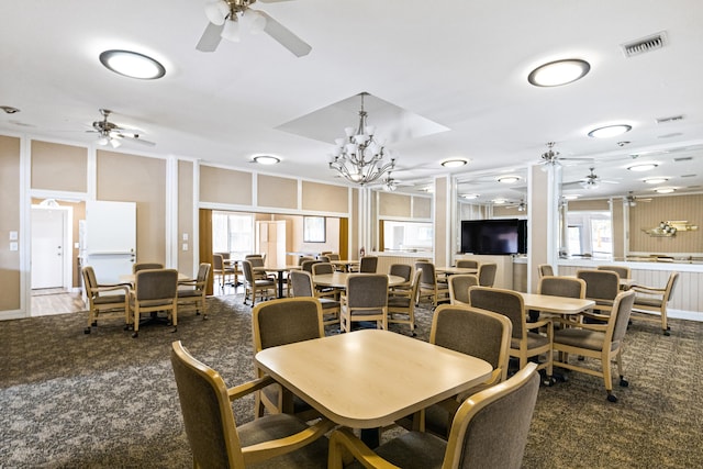 dining area with dark carpet and ceiling fan