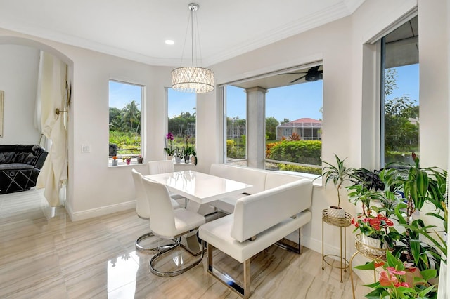 dining room with crown molding and a chandelier