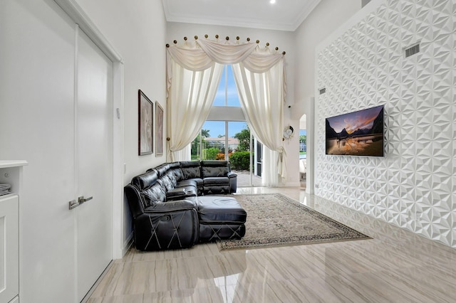 living room with crown molding and a high ceiling