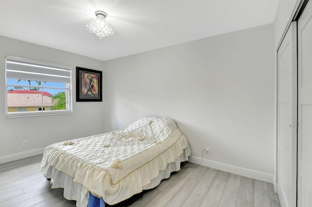 bedroom with a closet and light wood-type flooring