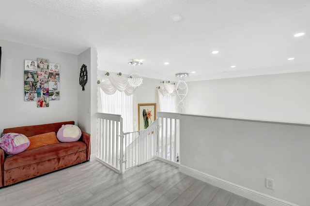 interior space with a textured ceiling and light wood-type flooring