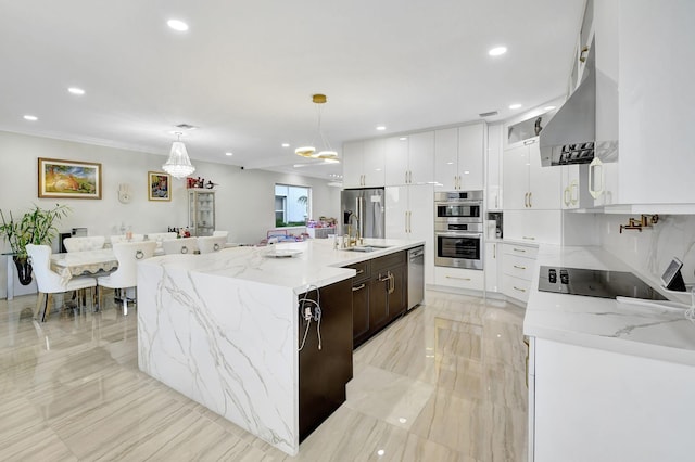 kitchen featuring appliances with stainless steel finishes, white cabinetry, hanging light fixtures, a kitchen island with sink, and dark brown cabinets