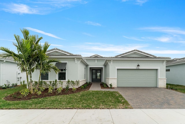 ranch-style house with a garage and a front yard