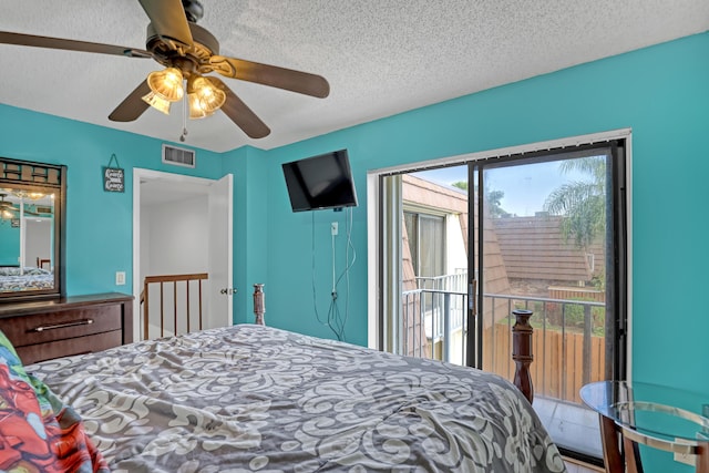 bedroom featuring a textured ceiling, access to outside, visible vents, and a ceiling fan