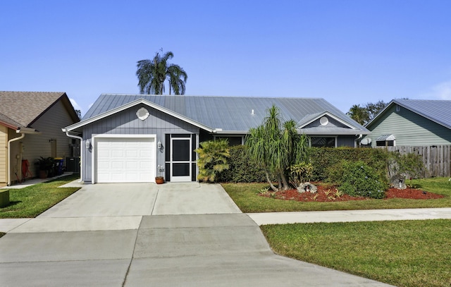 ranch-style home featuring a garage and a front lawn