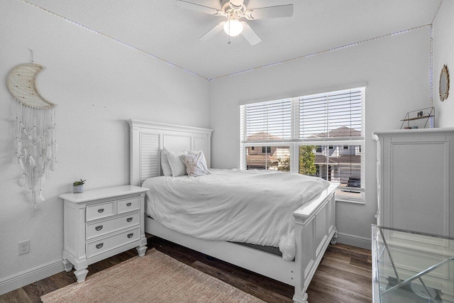 bedroom featuring a ceiling fan, dark wood-style floors, and baseboards