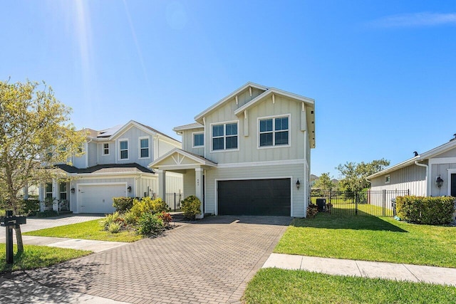 view of front of property with decorative driveway, a garage, fence, and board and batten siding