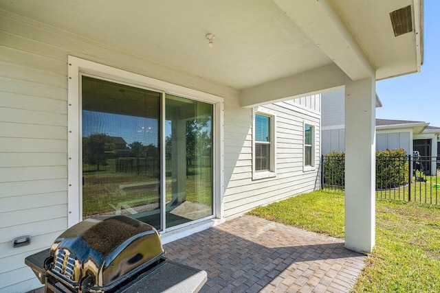 view of patio / terrace with visible vents, grilling area, and fence