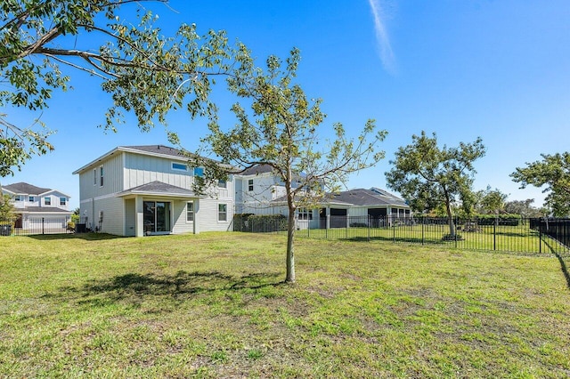 back of property with a yard and a fenced backyard