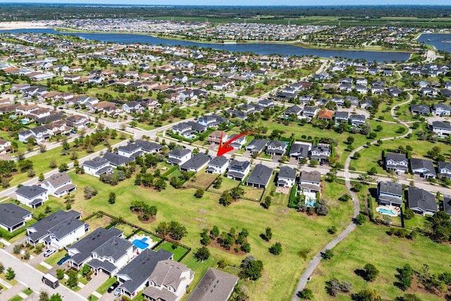 drone / aerial view with a residential view and a water view