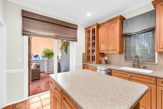 kitchen with dishwasher, tasteful backsplash, a sink, and glass insert cabinets