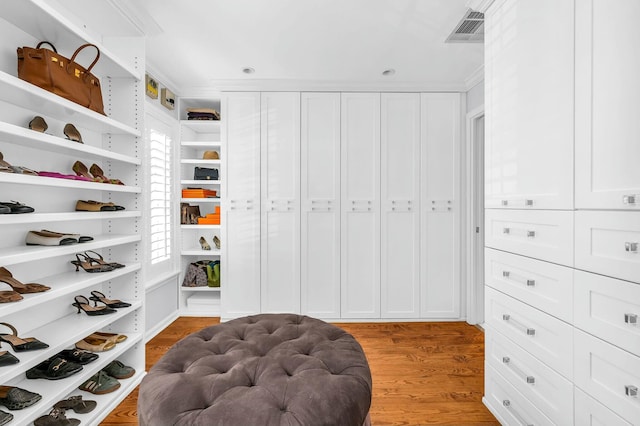 walk in closet featuring light wood-type flooring and visible vents