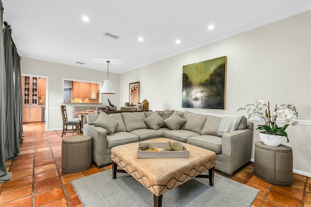 living room with crown molding, baseboards, visible vents, and recessed lighting