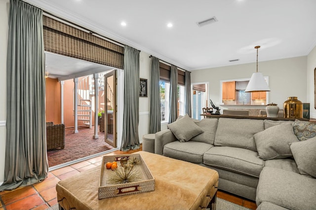 living room with light tile patterned floors, ornamental molding, visible vents, and recessed lighting