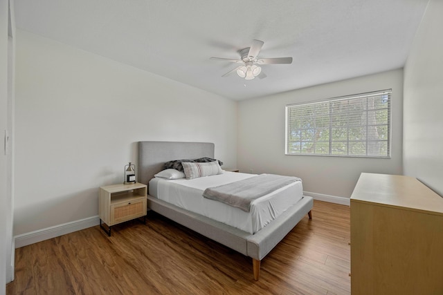 bedroom with hardwood / wood-style floors and ceiling fan