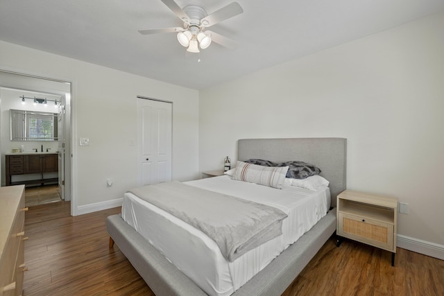 bedroom featuring ceiling fan, dark hardwood / wood-style floors, and sink