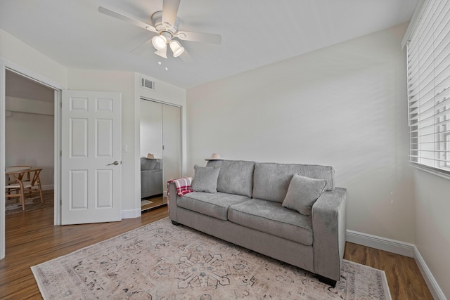 living room featuring ceiling fan and light hardwood / wood-style flooring