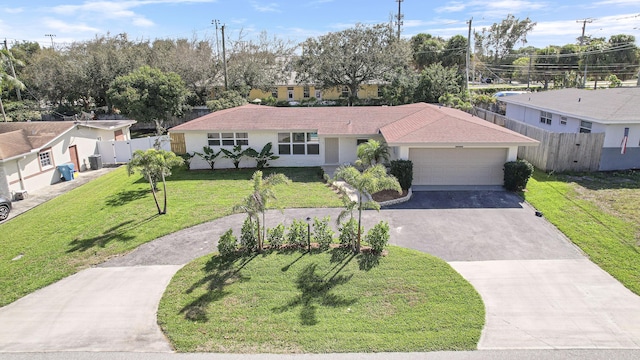 single story home with an attached garage, fence, a front lawn, and aphalt driveway