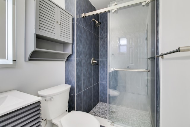 full bath with toilet, a shower stall, and vanity