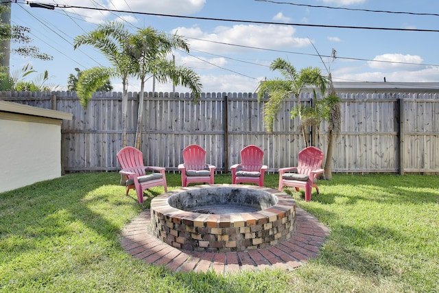 view of yard with an outdoor fire pit and fence