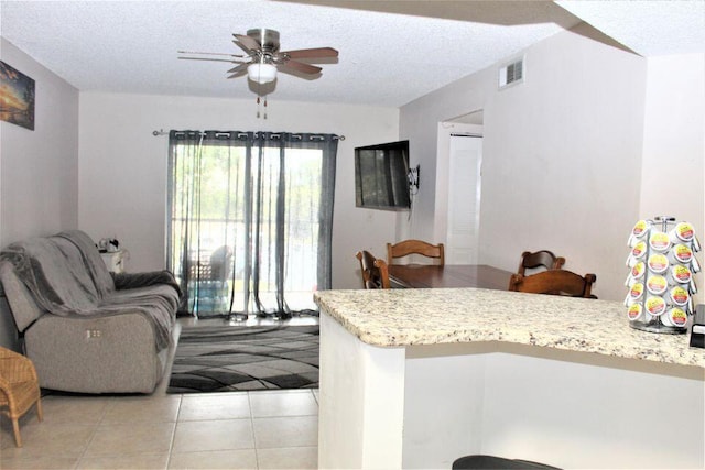 interior space featuring ceiling fan and a textured ceiling