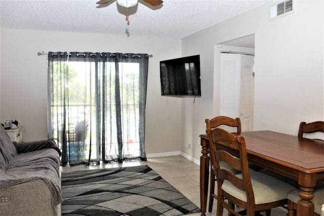 interior space featuring ceiling fan and a textured ceiling