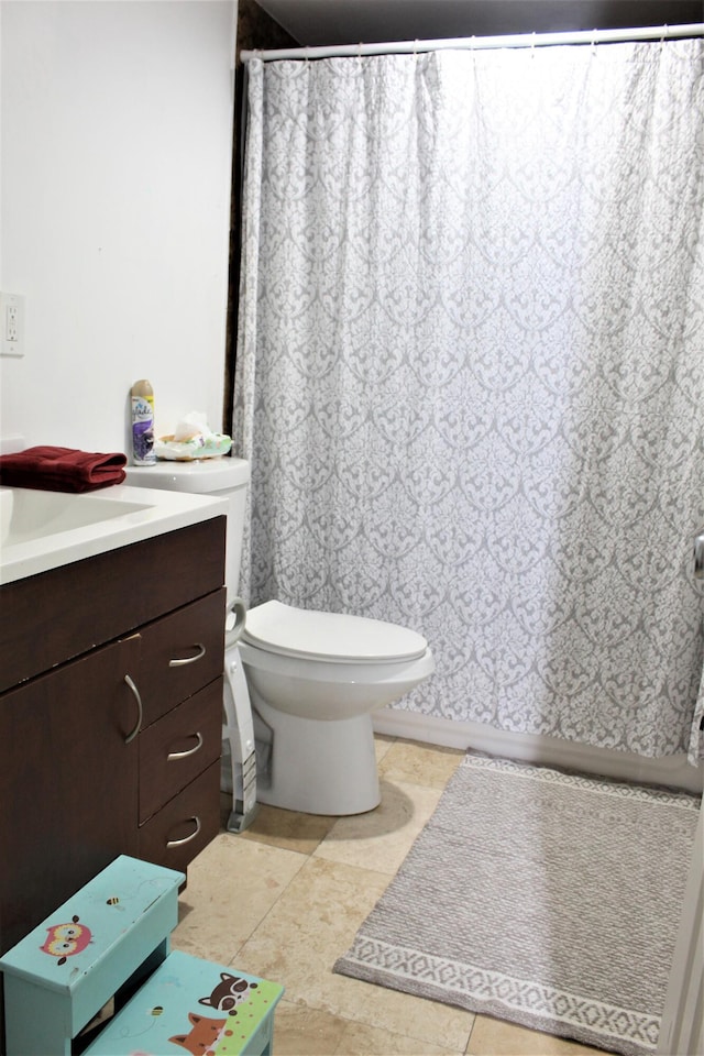 bathroom featuring vanity, toilet, and tile patterned flooring