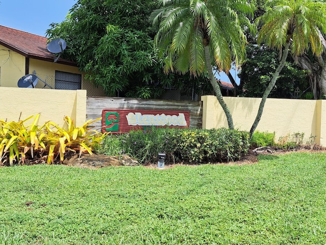 community / neighborhood sign with a lawn