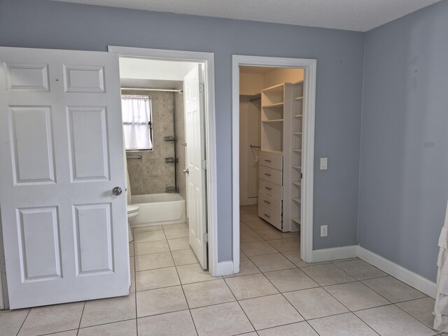 kitchen with vaulted ceiling with beams, open floor plan, a sink, and light tile patterned floors